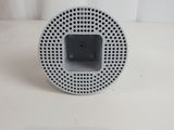 a close up of a speaker on a white surface