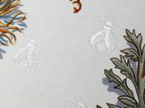 a close up of a table cloth with a design on it