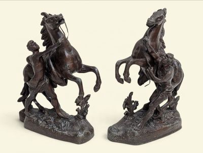 two statues of a man on a horse and a man on a horse