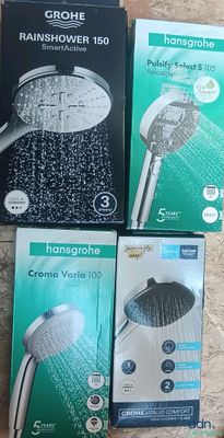 four different types of shower heads and hoses on a table
