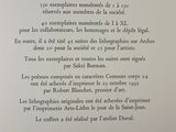 an open book with a poem written in french on it