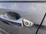a close up of a car door handle with a sticker on it