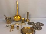 several brass objects are sitting on a white surface