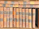 many old books in a cardboard box on the shelf