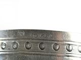 a close up of a silver plate with holes on it