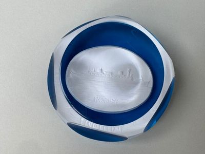 a blue and white plate with a picture of a city on it