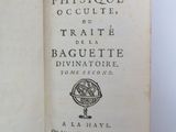 an open book with a black and white image of a compass on it