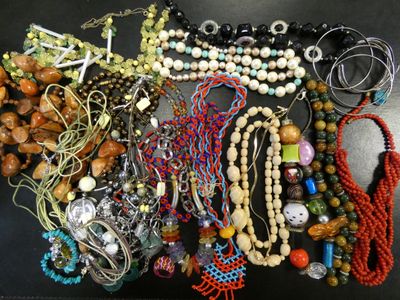 a lot of beads and necklaces on a table