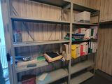 a room that has a shelf with many books on it