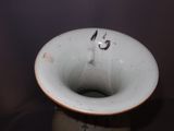 a white vase with black writing on it sitting on a table