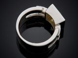 a close up of a ring on a table with a black background