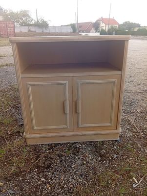 a cabinet that is sitting on the ground in the dirt