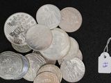 a pile of coins and a tag on a black surface