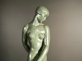 an image of a statue of a woman standing on a marble base