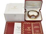 a box with a watch inside of it on a white surface
