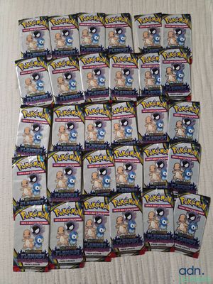 a pile of pokemon trading cards sitting on top of a table