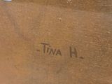 painting of a blue rose on a wooden table with a name written on it
