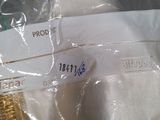 a white shirt with a gold band on it