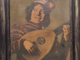 an old painting of a man playing a lute in a wooden frame