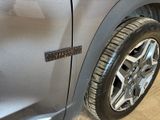 a close up of a car ' s door handle with a sticker on it