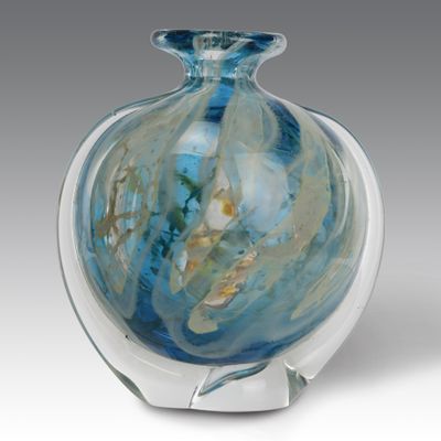 a glass vase that has a blue and white design on it