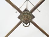 a close up of a metal object with a lion ' s head on it
