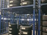 a lot of tires stacked on a rack in a warehouse
