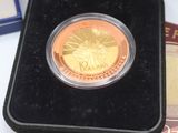 a gold coin sitting in a black case on a table