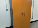 a wooden cabinet in the corner of a room