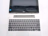 a laptop computer sitting on top of a white table