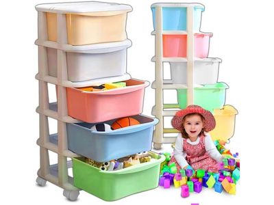 a small child that is sitting in front of a stack of bins