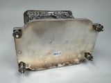 an antique silver plate with a handle and a handle on it
