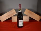 a bottle of wine sitting on a table next to wooden blocks