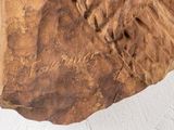 a piece of wood that has been carved into the shape of an elephant