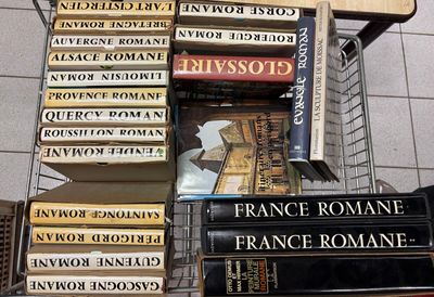 many books stacked on top of each other on a shelf