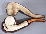 a pipe and a skull in a case on a table