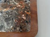a marble slab on a wooden stand on a table