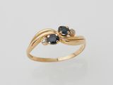 a close up of a gold ring with black and white diamonds