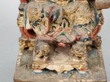 an image of a statue of a man sitting on top of a table