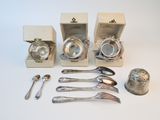 silverware and spoons sitting on a white table