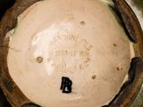 a close up view of a bowl with a black elephant on it