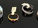 four different types of rings are displayed on a black surface