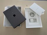 an apple ipad is sitting in a box next to a charger