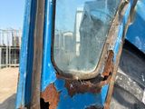 a close up of a rusted door of a blue truck
