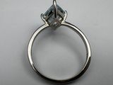 a close up of a ring with a blue topaz stone on it