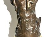 bronze statue of a woman holding a bird on a marble base