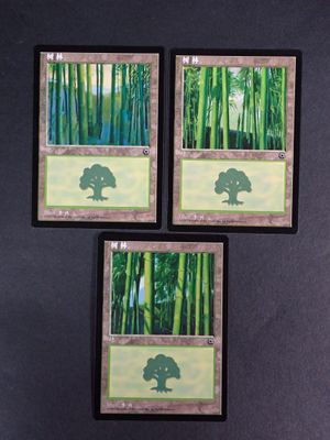 three cards with a picture of a tree on them on a table