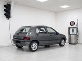 a car that is parked in a garage next to a gas pump