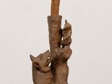 a wooden sculpture of a man holding a baseball bat