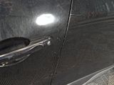 a close up of a door handle on a black car